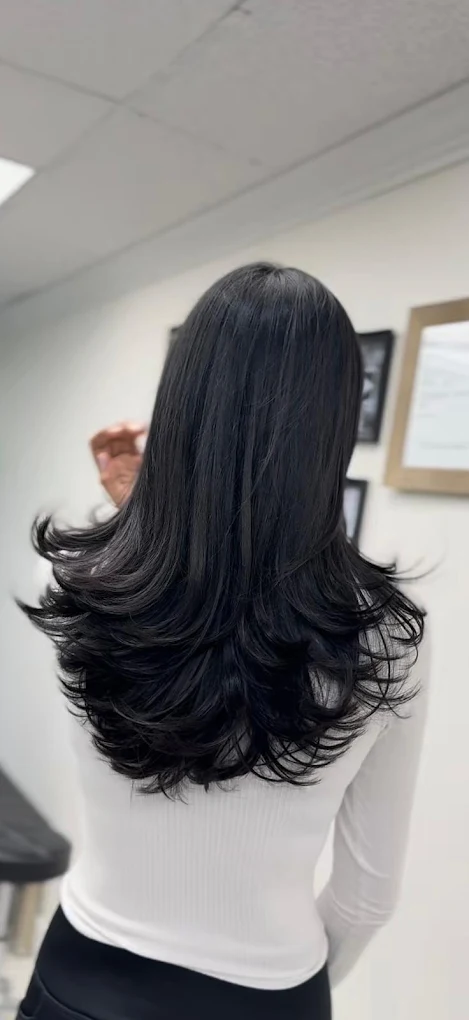 Black layered haircut with bouncy flipped ends at Lux Hair Surrey