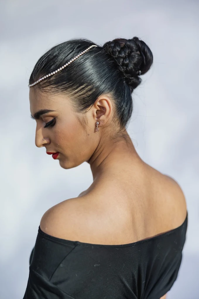 Sleek braided bridal bun with jeweled headpiece by Surrey bridal hair artist