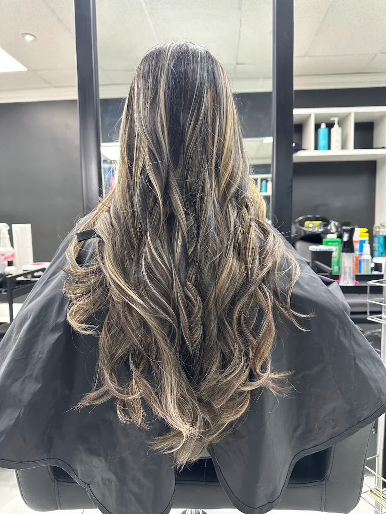 Dimensional highlights on long layered hair by Surrey colour specialist