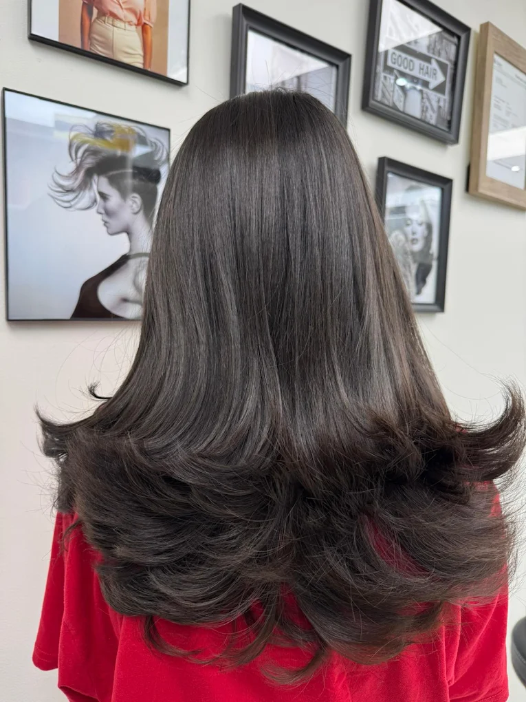 Layered brunette haircut with luxury bouncy blowout in Surrey BC