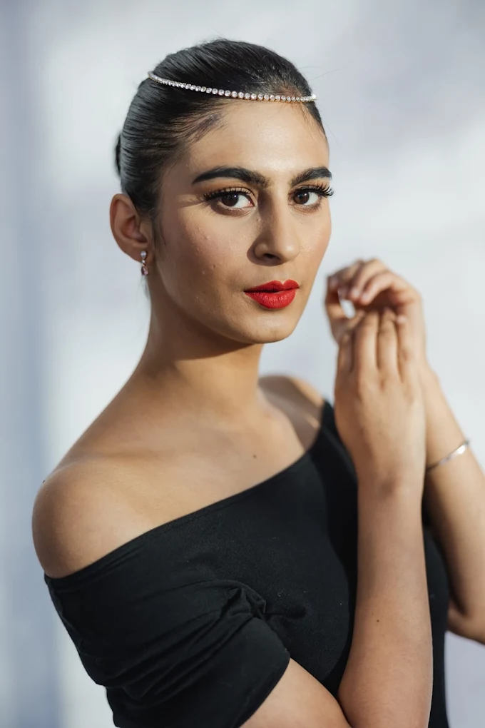 Party makeup with red lip and sleek bun by Surrey makeup artist Manpreet