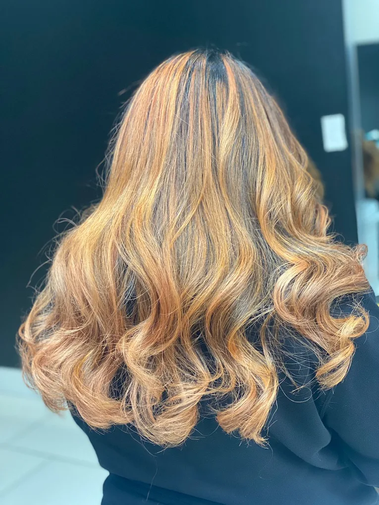 Warm caramel highlights with bouncy curls at Lux Hair Surrey BC